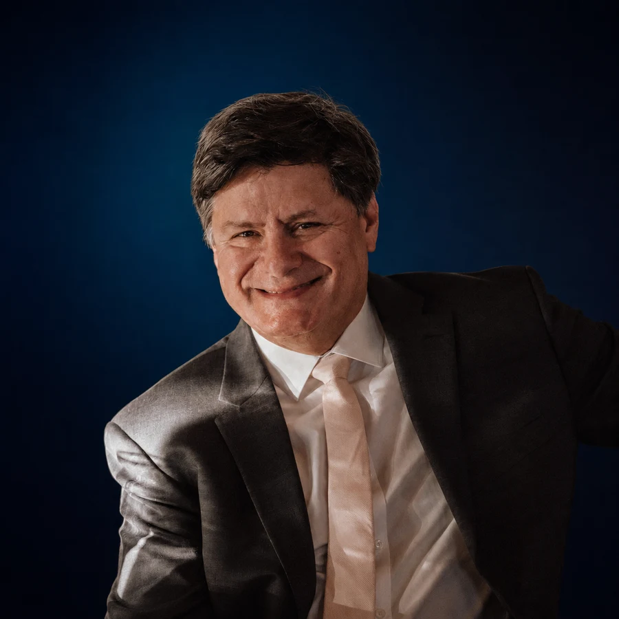 Ricardo Garcia smiling in a suit